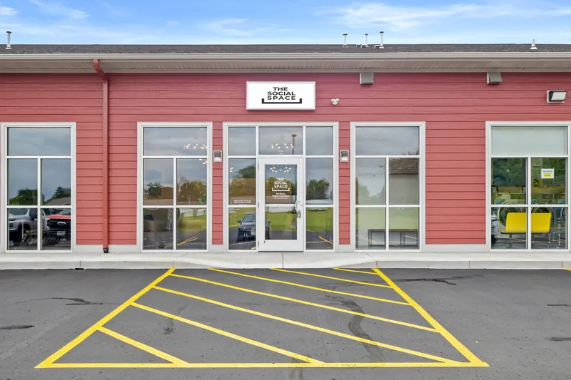 The Social Space storefront with its sign and parking