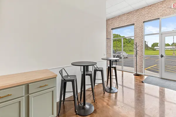 High-top tables and stools by the window