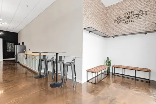 Entry benches with high-top tables and the kitchenette beyond
