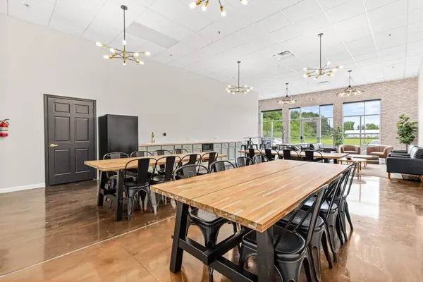 Long table in the foreground with the window wall at the far end
