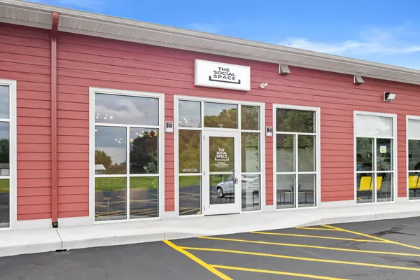 Exterior at an angle with the entry door and sign