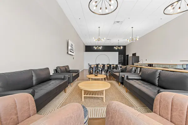 Lounge sofas in the foreground with dining tables at the far end
