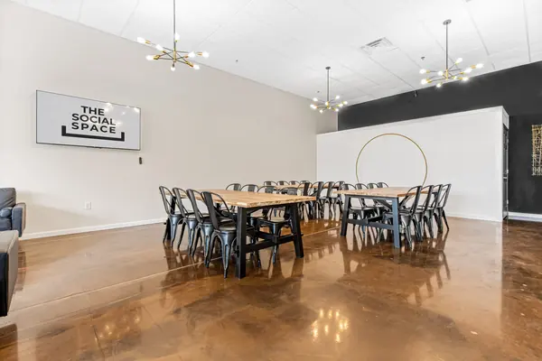 Tables facing the TV with the gold-ring wall at right