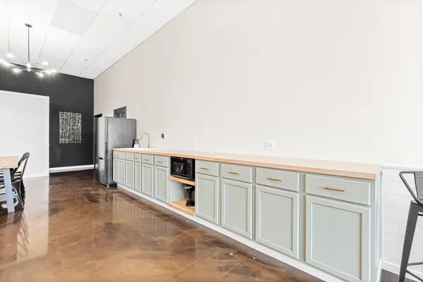 Kitchenette counter with sink, microwave and coffee maker