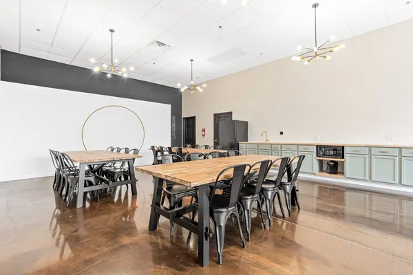 Corner view of the dining tables, kitchenette and chandeliers