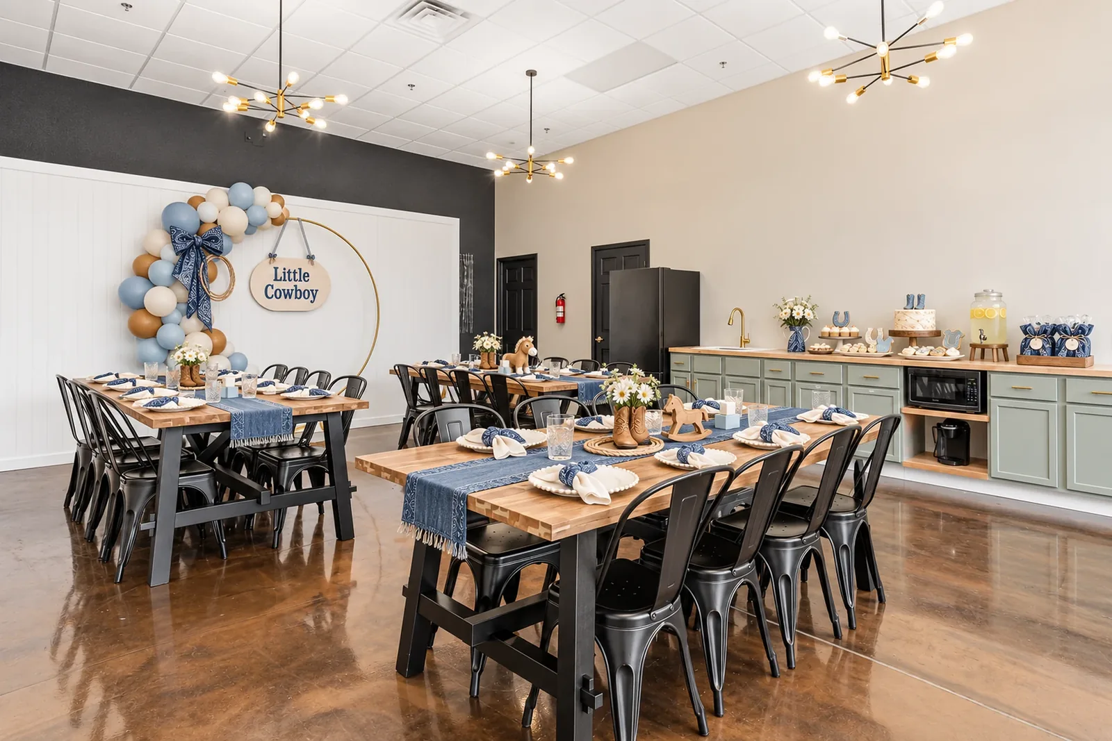 The same room styled for a little-cowboy baby shower: blue balloon arch, denim runners and boots