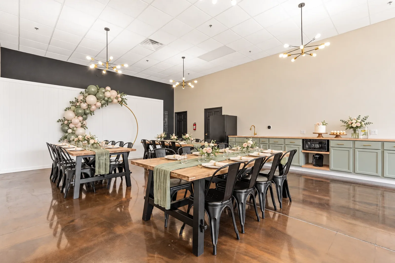 AI-rendered styling idea: the room set for a bridal shower with a sage and blush balloon arch