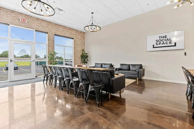 Window wall with high-top tables and the entry door